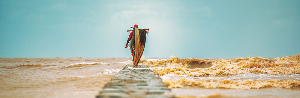 Fisherman Walking On A Damn